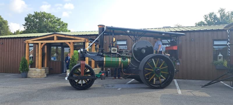 The Aviary Ormskirk from the car park, a low timber-and-brick building with a porch, a steam traction engine parked in front
